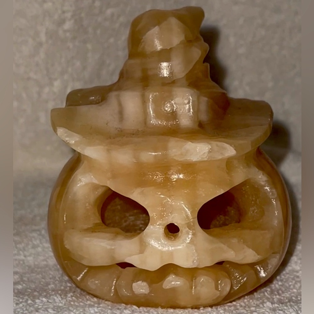 Natural orange calcite witch pumpkin head